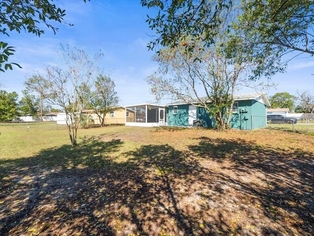 back of house with a sunroom, a yard, and fence