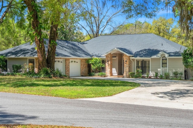 view of front of property featuring a garage, roof with shingles, concrete driveway, and a front lawn