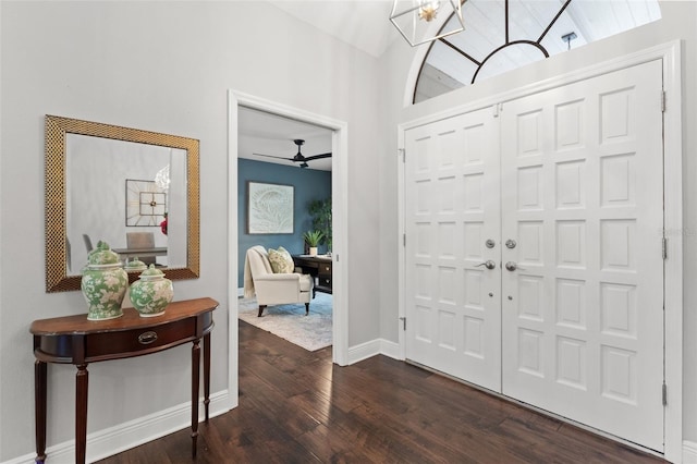 entryway with baseboards, dark wood-style floors, and vaulted ceiling