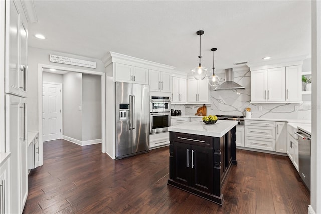 kitchen with white cabinets, stainless steel appliances, and wall chimney range hood