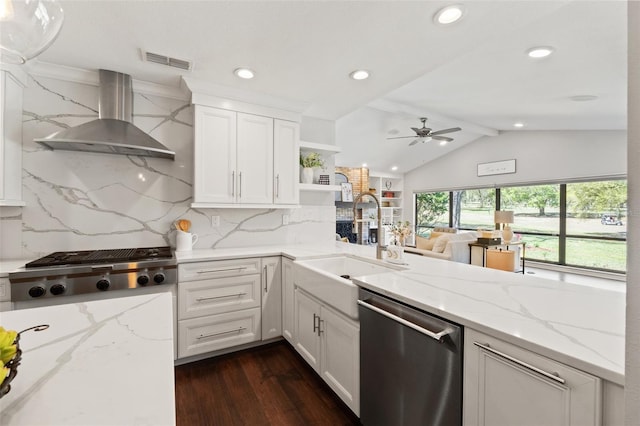 kitchen featuring visible vents, a sink, open shelves, stainless steel appliances, and wall chimney exhaust hood