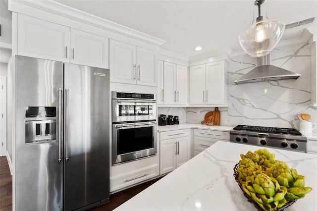 kitchen with white cabinetry, backsplash, and appliances with stainless steel finishes