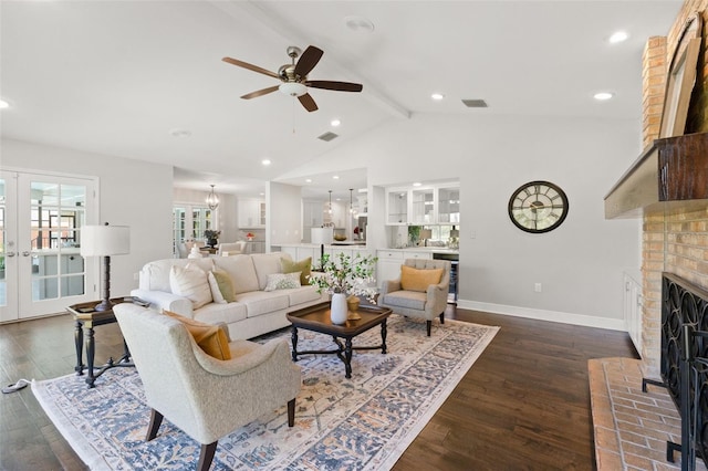 living area with visible vents, dark wood-type flooring, a brick fireplace, and french doors