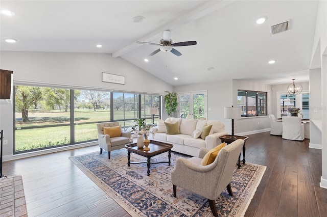 living area with visible vents, baseboards, lofted ceiling with beams, ceiling fan with notable chandelier, and dark wood-style flooring