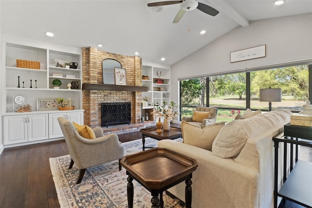 living room with built in shelves, ceiling fan, beam ceiling, a fireplace, and dark wood-style floors