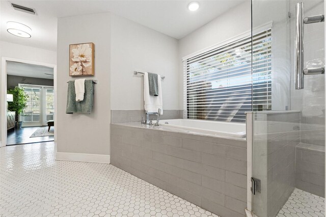 full bathroom featuring baseboards, visible vents, a stall shower, a garden tub, and connected bathroom