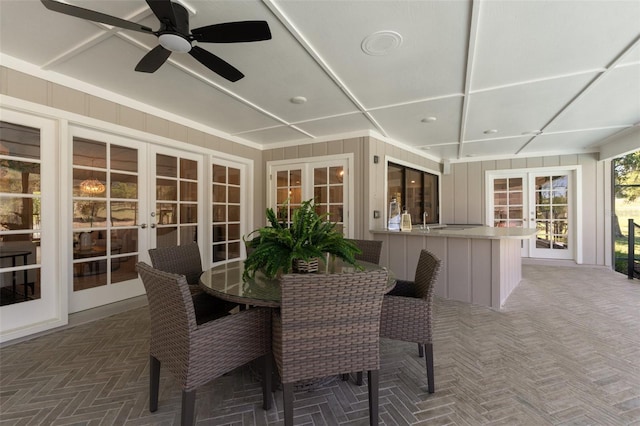 sunroom / solarium with french doors and ceiling fan