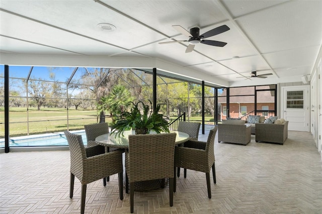 sunroom featuring ceiling fan