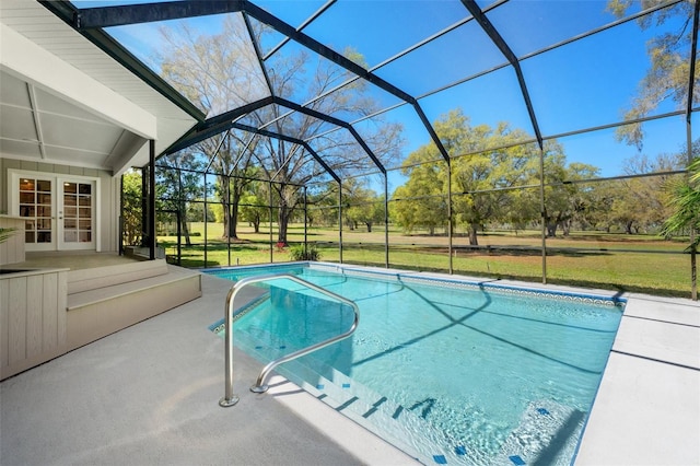 outdoor pool featuring french doors, a yard, glass enclosure, and a patio area