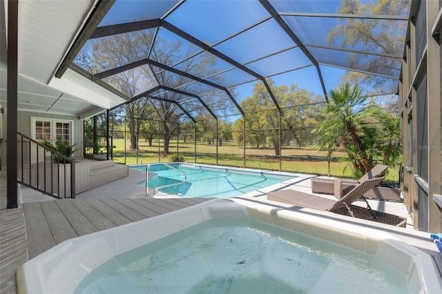 pool featuring a lanai, an in ground hot tub, and a wooden deck