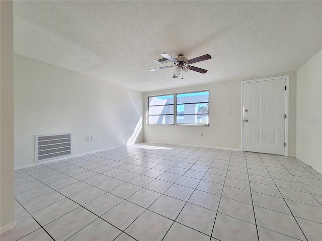 unfurnished room with ceiling fan, light tile patterned floors, a textured ceiling, and visible vents