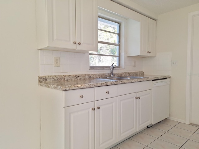 kitchen with decorative backsplash, white cabinets, white dishwasher, and a sink