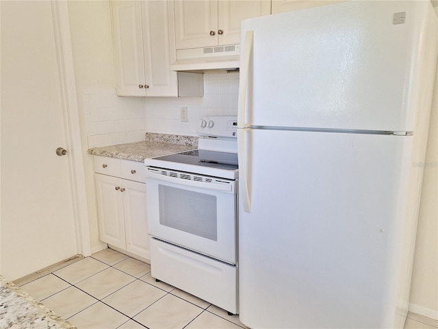 kitchen featuring white appliances, tasteful backsplash, light tile patterned floors, white cabinets, and under cabinet range hood