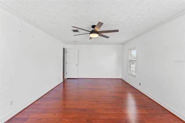 unfurnished room with visible vents, wood finished floors, a ceiling fan, and ornamental molding