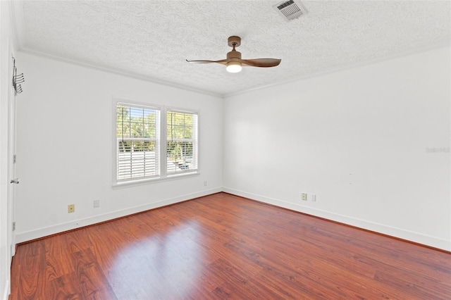 spare room with visible vents, a textured ceiling, wood finished floors, baseboards, and ceiling fan