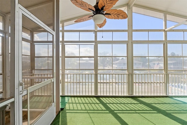 unfurnished sunroom with vaulted ceiling and ceiling fan