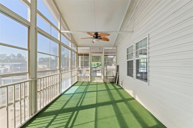 unfurnished sunroom with ceiling fan