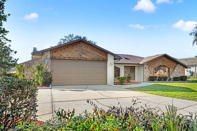 mid-century home featuring a garage, a front lawn, concrete driveway, and stucco siding