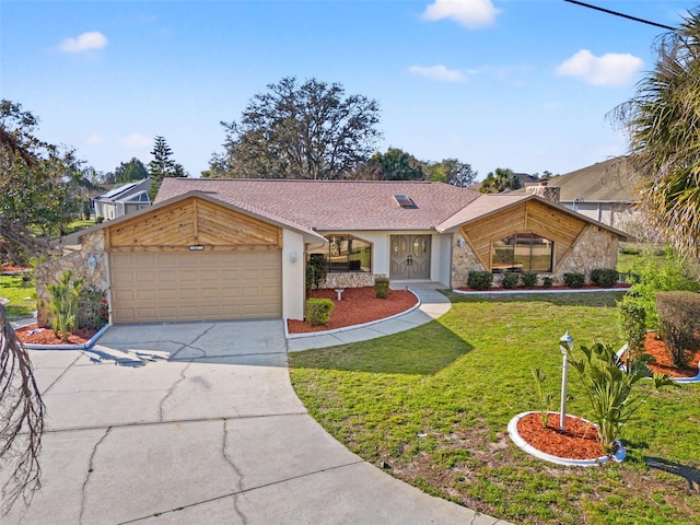 view of front facade with a garage, concrete driveway, stone siding, a front lawn, and stucco siding