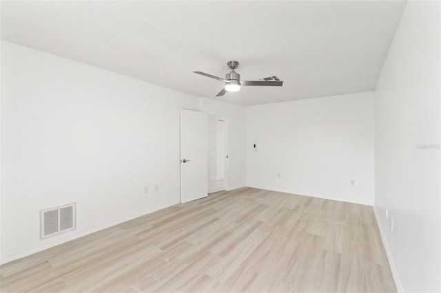 empty room with light wood-type flooring, visible vents, and a ceiling fan