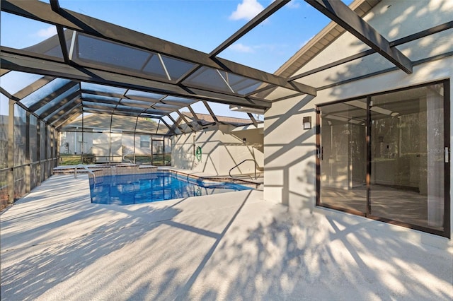 pool featuring a patio area and glass enclosure