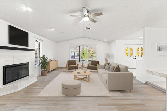 1011 Altoona Ave, Spring Hill, FL 34609 - living area with lofted ceiling, a ceiling fan, light wood-style flooring, a tiled fireplace, and recessed lighting