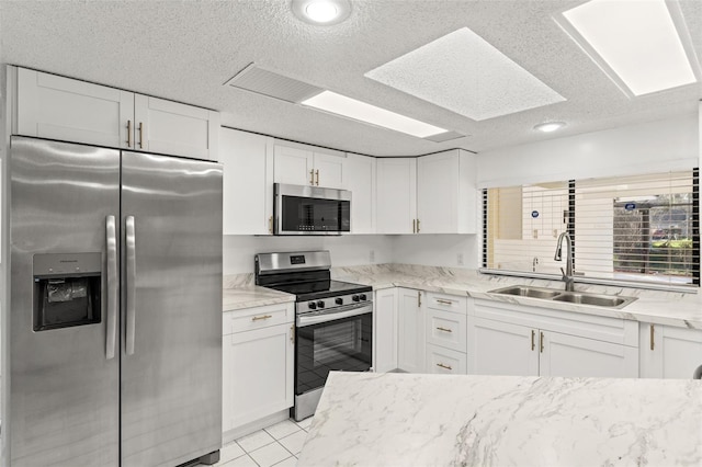 1011 Altoona Ave, Spring Hill, FL 34609 - kitchen with appliances with stainless steel finishes, a sink, white cabinetry, light stone counters, and a textured ceiling