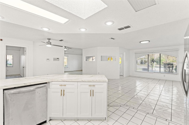 1011 Altoona Ave, Spring Hill, FL 34609 - kitchen with dishwasher, open floor plan, recessed lighting, white cabinetry, and a skylight