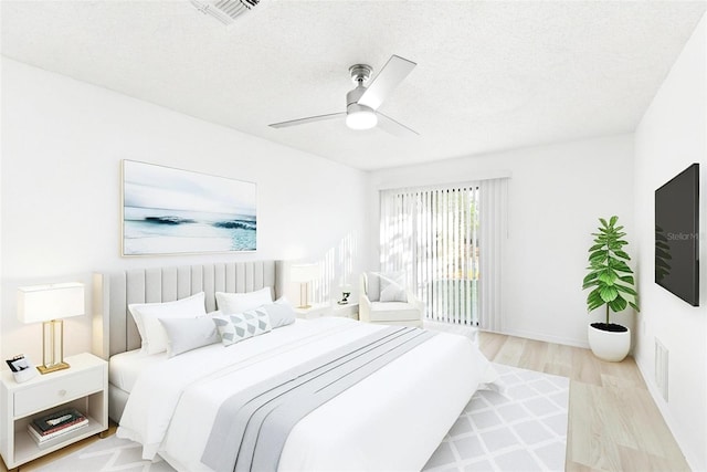 1011 Altoona Ave, Spring Hill, FL 34609 - bedroom featuring wood finished floors, a textured ceiling, ceiling fan, and baseboards