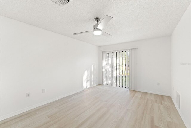 1011 Altoona Ave, Spring Hill, FL 34609 - empty room with light wood-type flooring, a textured ceiling, a ceiling fan, and baseboards