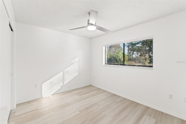 1011 Altoona Ave, Spring Hill, FL 34609 - spare room featuring wood finished floors, a ceiling fan, a textured ceiling, and baseboards