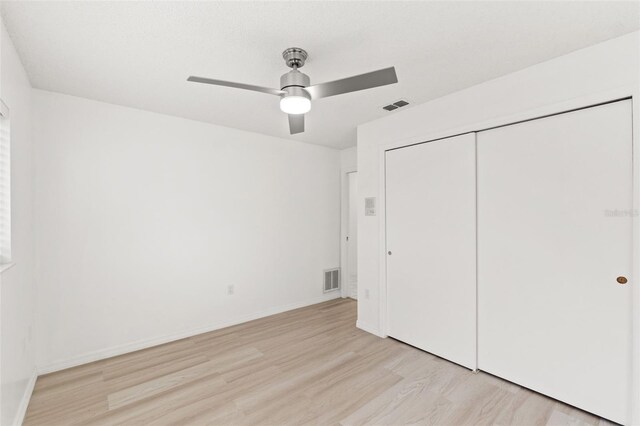1011 Altoona Ave, Spring Hill, FL 34609 - unfurnished bedroom with light wood finished floors, a closet, baseboards, and ceiling fan