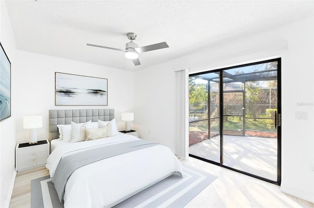 1011 Altoona Ave, Spring Hill, FL 34609 - bedroom with access to exterior, light wood finished floors, ceiling fan, baseboards, and a textured ceiling