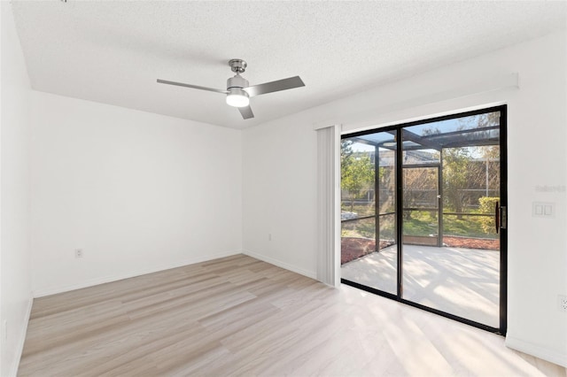 1011 Altoona Ave, Spring Hill, FL 34609 - unfurnished room featuring light wood finished floors, a ceiling fan, baseboards, and a textured ceiling
