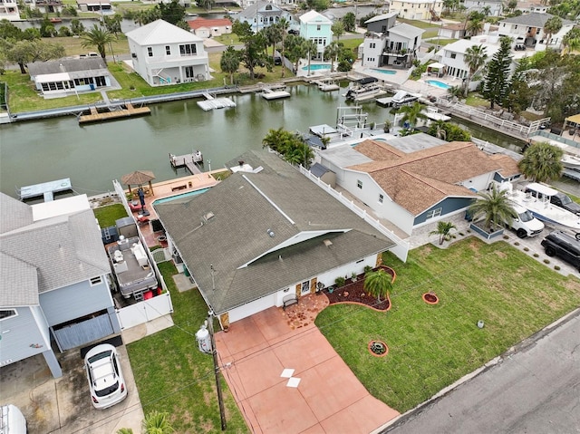 drone / aerial view with a water view and a residential view