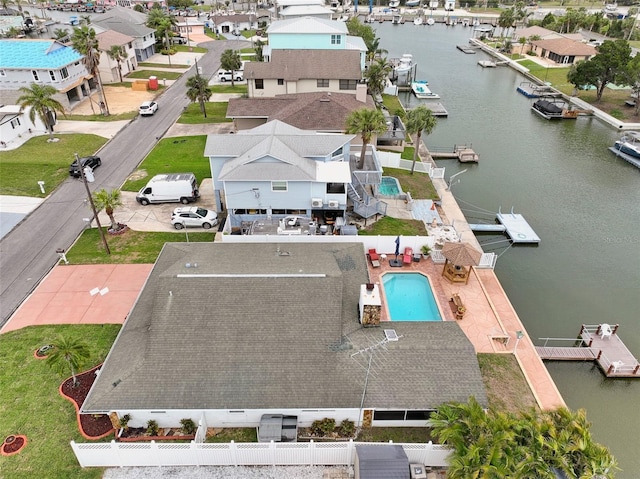 drone / aerial view with a water view and a residential view