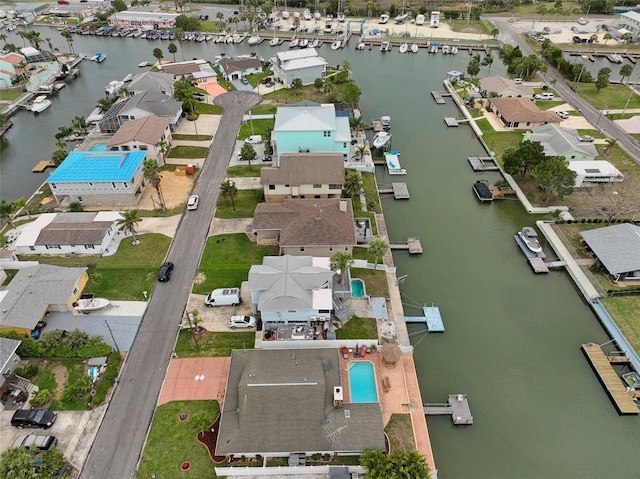 drone / aerial view featuring a water view and a residential view