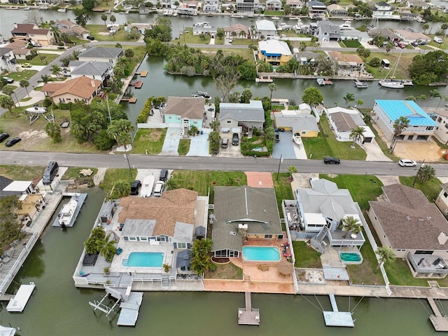 birds eye view of property with a residential view and a water view