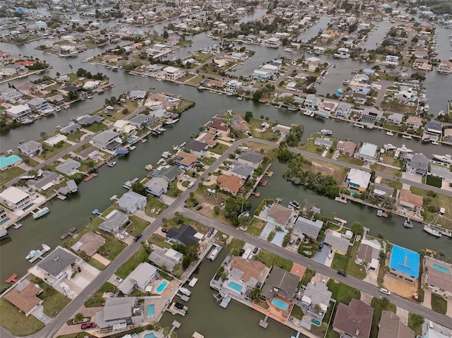 birds eye view of property with a water view and a residential view