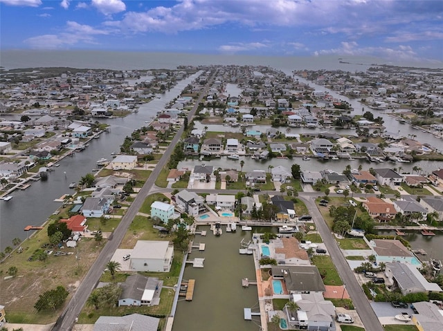 birds eye view of property with a water view and a residential view