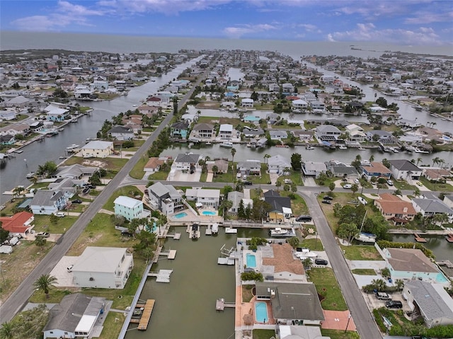 birds eye view of property with a residential view and a water view