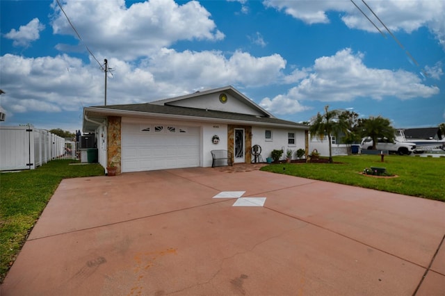 single story home with driveway, an attached garage, fence, a front yard, and stucco siding