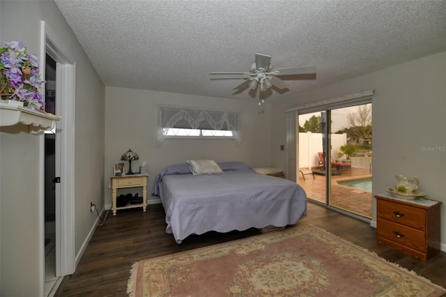 bedroom featuring access to outside, a textured ceiling, baseboards, and wood finished floors