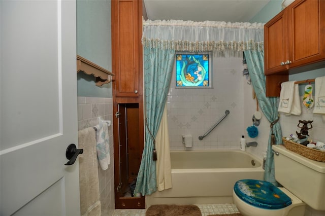 bathroom with toilet, shower / bath combination with curtain, tile walls, and wainscoting