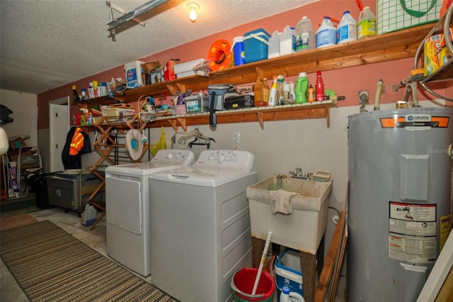 laundry area featuring water heater, a sink, a textured ceiling, washer and dryer, and laundry area