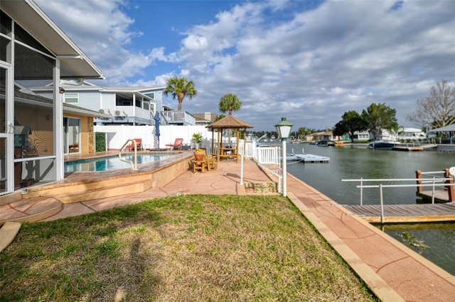 exterior space with a water view, fence, a gazebo, a fenced in pool, and a patio area