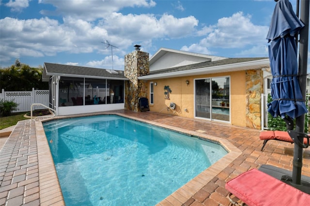 view of pool featuring a sunroom, fence, a fenced in pool, and a patio