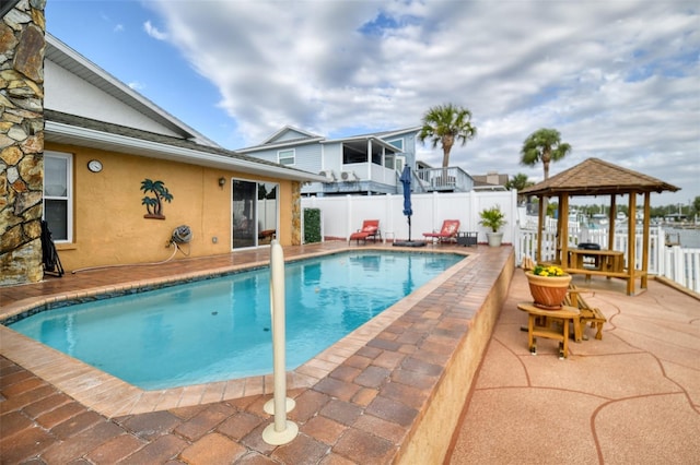 view of pool with a fenced in pool, a patio area, fence, and a gazebo