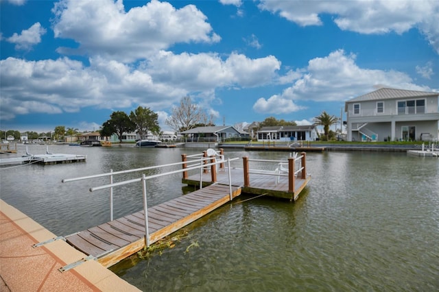 view of dock featuring a water view and a residential view