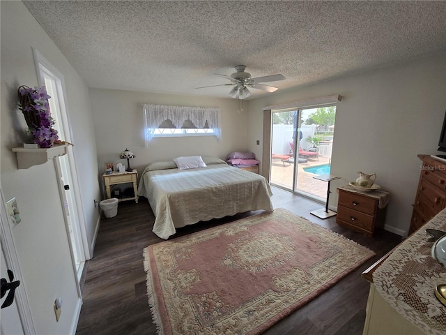bedroom featuring a ceiling fan, dark wood-style flooring, a textured ceiling, and access to exterior